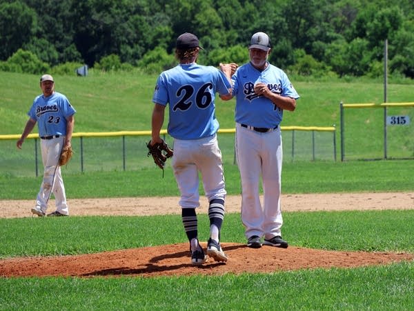 baseball players stand near each other 