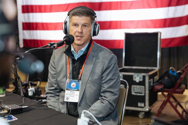 A man speaks into a microphone.