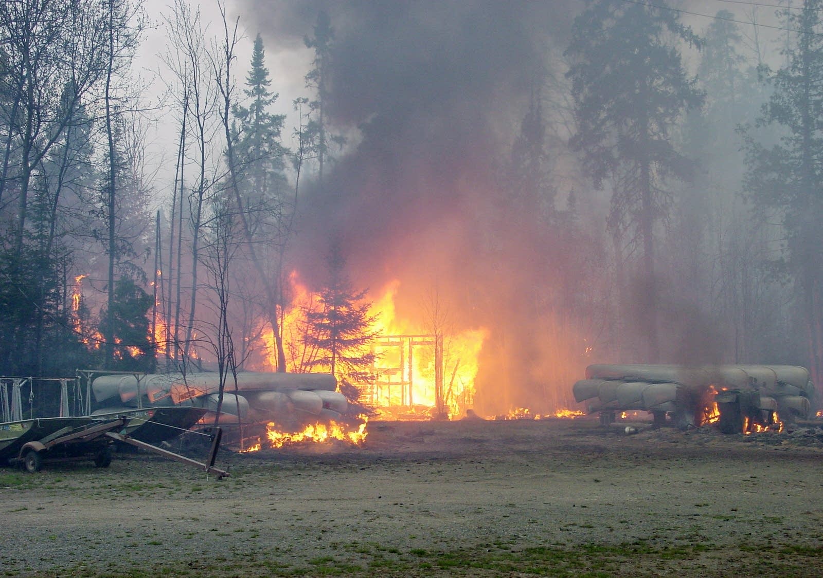 An outfitter is a complete loss before firefighters could save it.