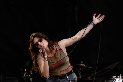 Couch performing on an outdoor stage.
