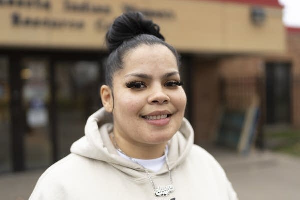 A woman poses for a photograph.