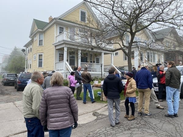 people gathered at Bob Dylan's childhood home