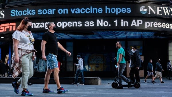 An electronic billboard in Times Square announces "stocks soar on vaccine hopes" on November 9, 2020 in New York City.