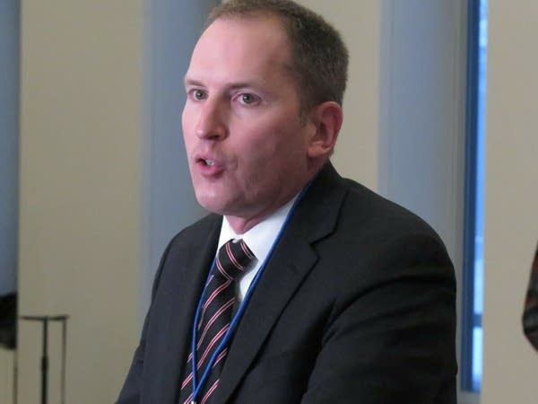 a man speaks at a podium.