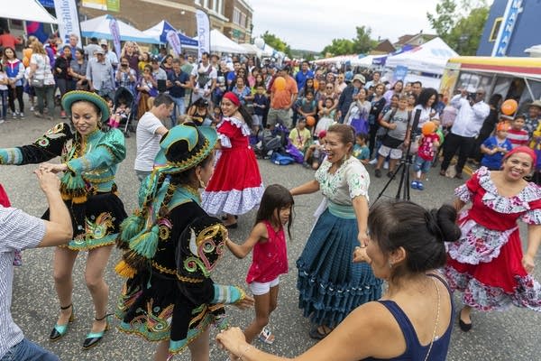 A crowd of people dancing in the street. 