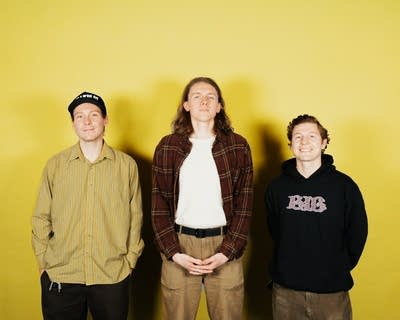 Three guys stand together for a studio portrait
