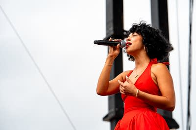 Monica Martin performing on an outdoor stage.