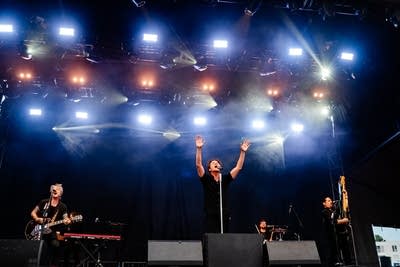 A band performing on a large outdoor stage