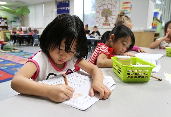 Kindergarteners Paw Soe, left, and Mi Meh