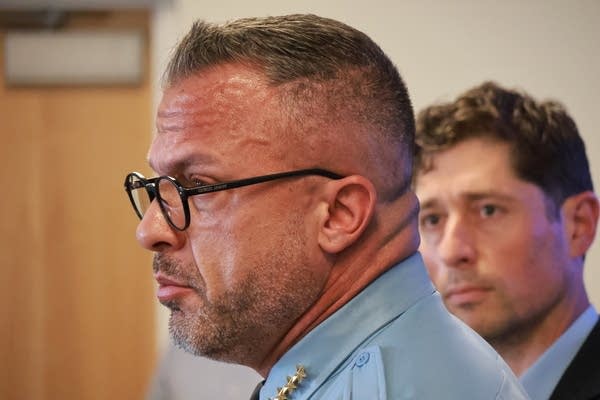chief in glasses at presser with mayor