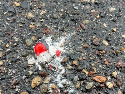 Less than lethal rounds are found on the ground.