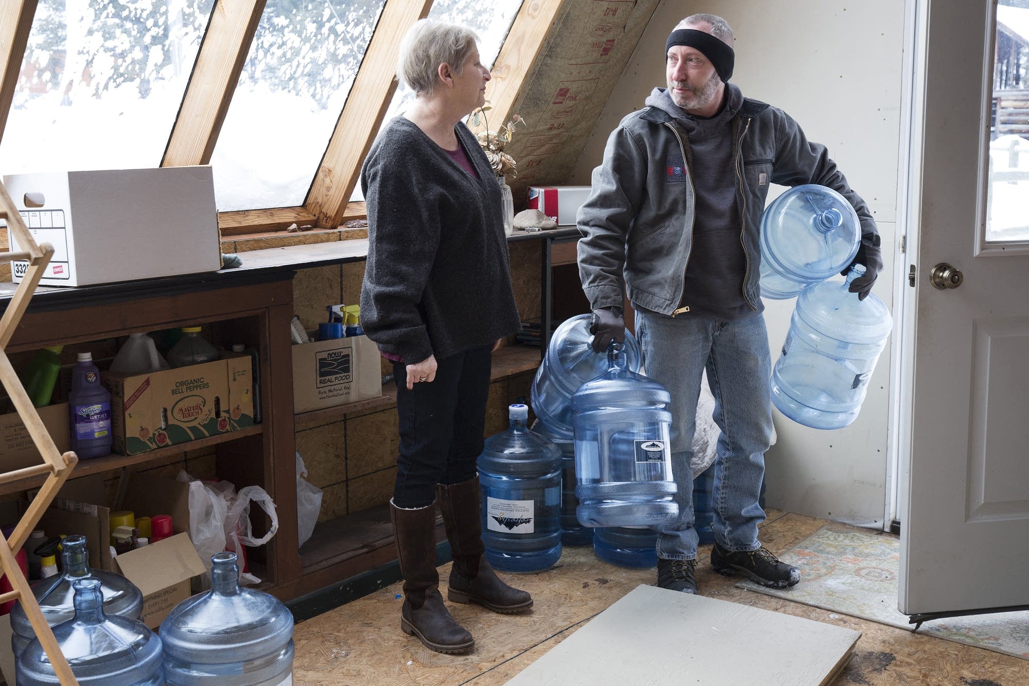 Catherine Maynard receives a bottled water delivery.