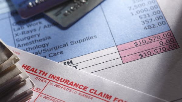 A health insurance claim form, credit cards, and bill.