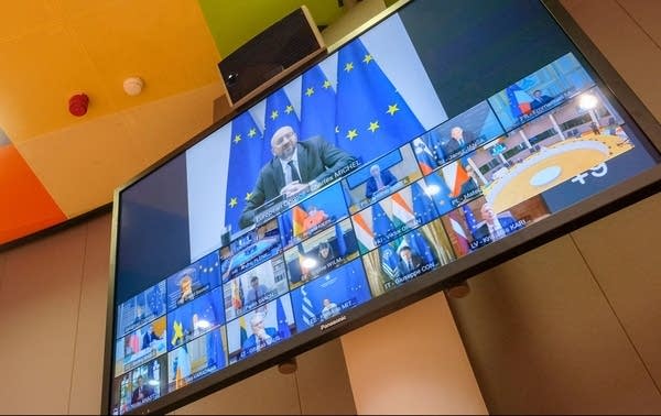 European Council President Charles Michel and other European leaders are seen on a screen as they attend a summit in video conference format, in Brussels.