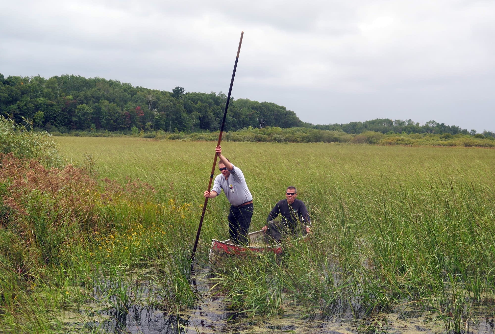 Bruce Martineau poles his father Francis Martineau to the shore.