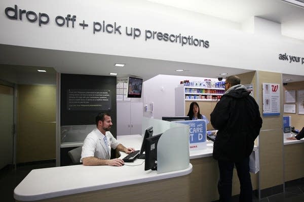 A pharmacist at the counter.