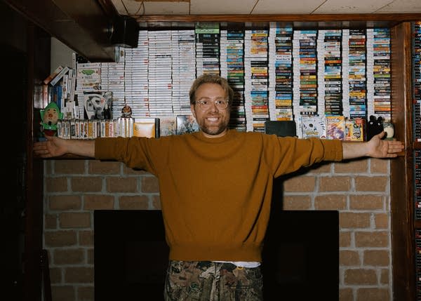 A person standing in front of a gaming collection 