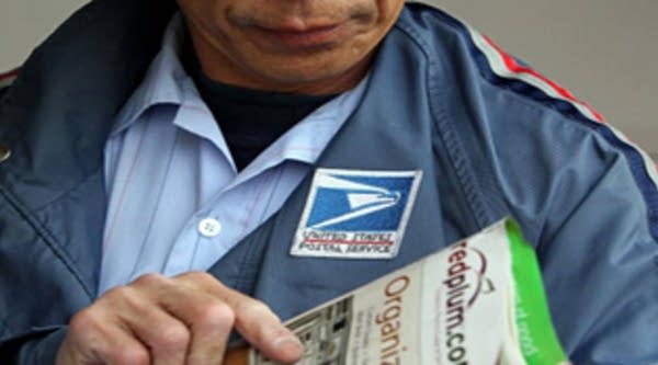 Postal Service letter-carrier Raymond Hou sorts through mail along his route in San Francisco.