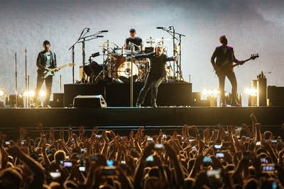 The Edge, Larry Mullen, Jr., Bono, and Adam Clayton of U2 performing at U.S. Bank Stadium in Minneapolis.