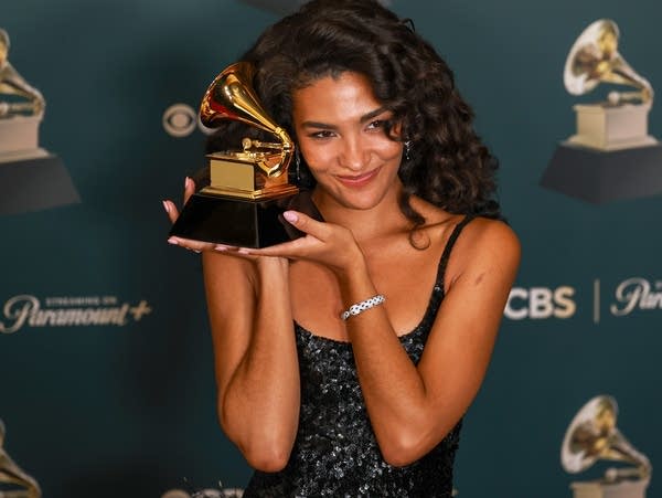 Olivia Dean holds up her Grammy Award