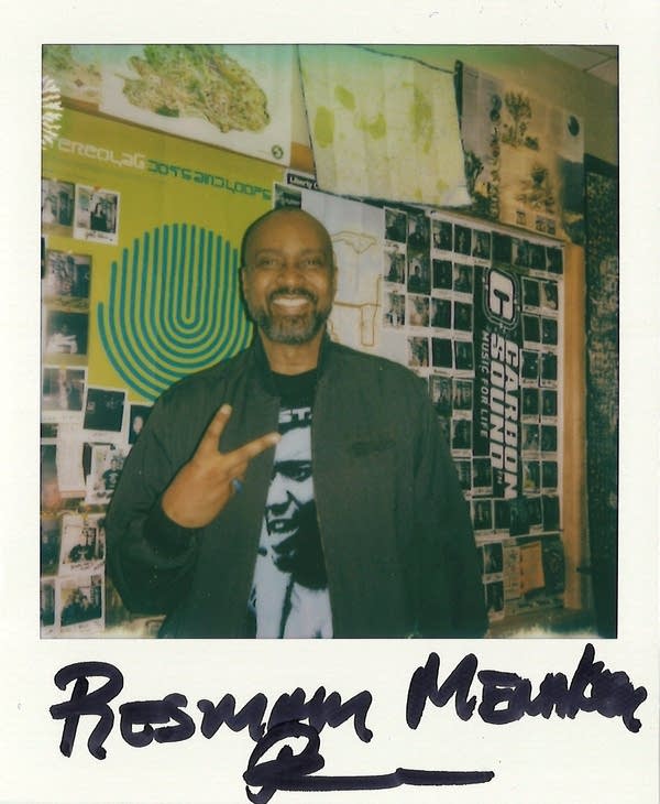 a man posing for a polaroid photo in the carbon sound studio