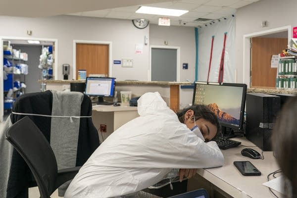 A medical staff member takes a short nap in nursing station in the COVID-19 intensive care unit at the United Memorial Medical Center in December in Houston, Texas. 