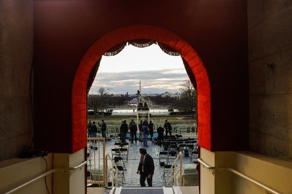 People prepare the inaugural platform for the presidential inauguration at the U.S. Capitol on Monday, Jan. 18, 2021 in Washington.