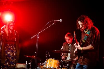 A band performing onstage in a music venue