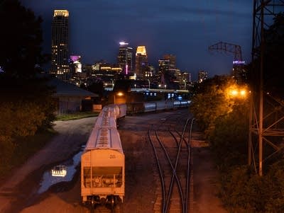 A view of the Minneapolis skyline with a train in the foreground