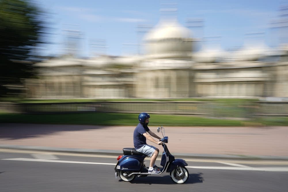 A scooter driving through Brighton in the summer of 2019