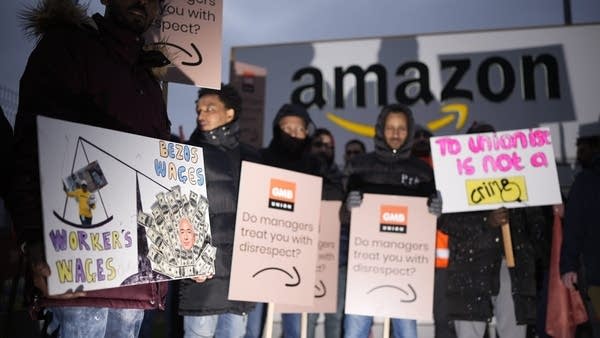 Amazon workers hold GMB union signs at a strike outside an Amazon fulfillment center in Coventry, England, in January.