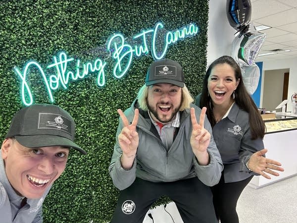 man poses with employees