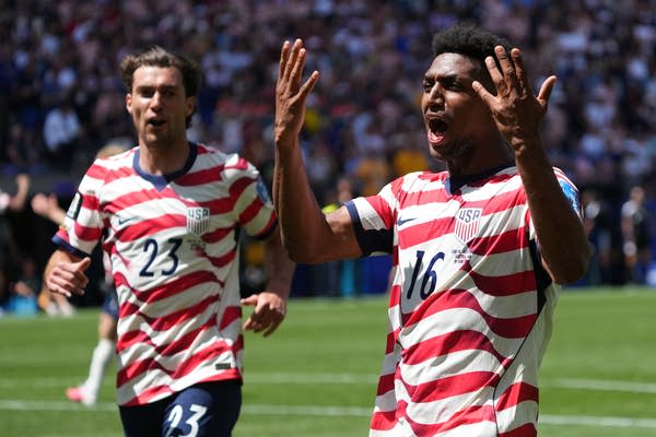 Two US soccer players reacting after goal