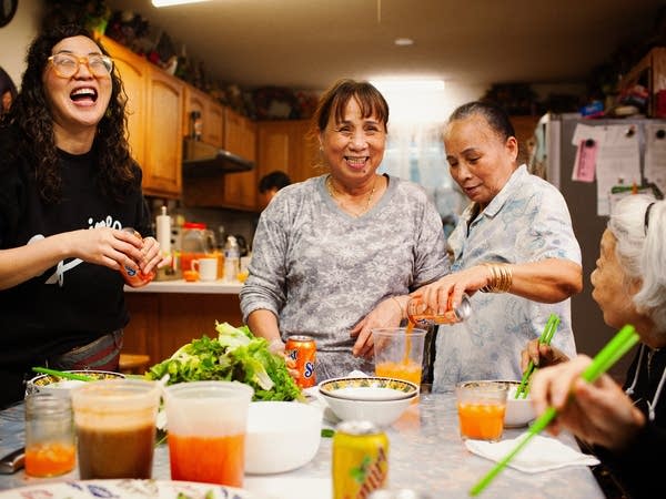 A fmaily smiling nad making food