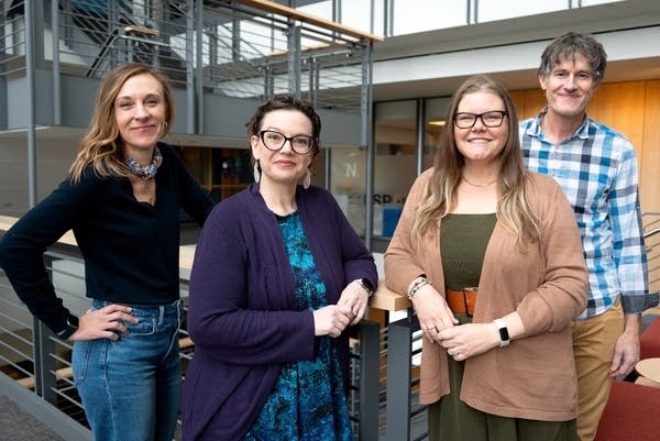 four people posing for a portrait