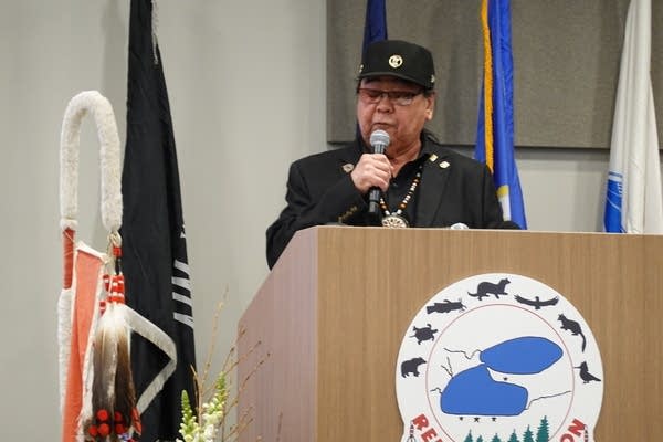 A person talks stands at a podium and talks