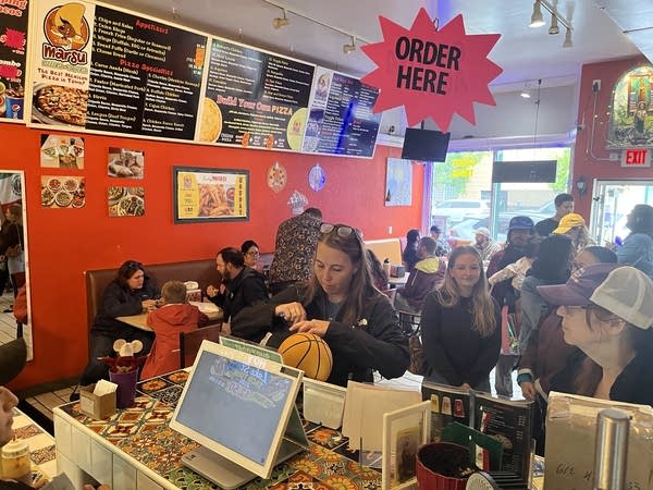 A restaurant is filled with customers.