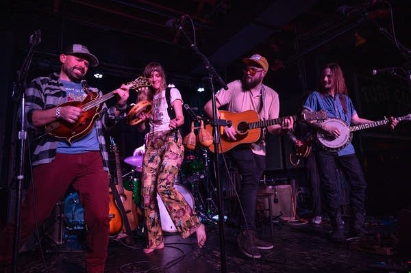 A string band performing onstage at a music venue