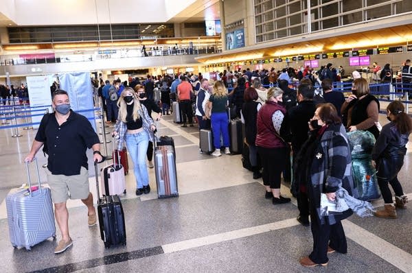 Travelers gather in the international terminal at Los Angeles International Airport (LAX) amid a surge in omicron variant cases on December 21, 2021 in Los Angeles, California. AAA estimates that over 109 million Americans will be traveling 50 miles or more during the holiday season between December 23 and January 2, an increase of 27.7% from 2020.