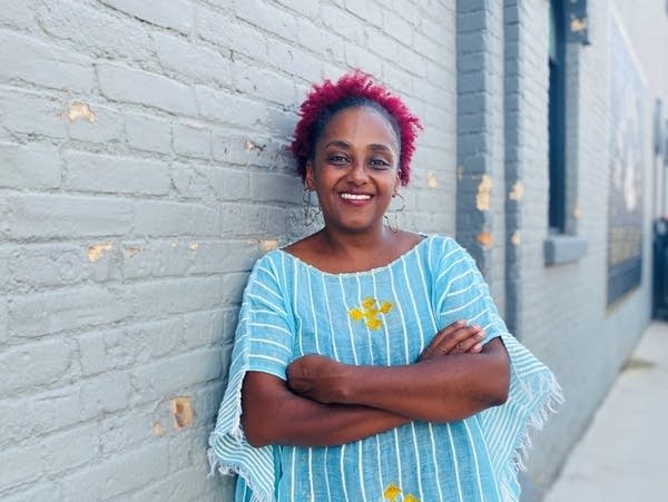 A woman poses for a photo and smiles