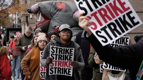 Washington Post employees walk a picket line during their 24-hour strike in December of last year. 