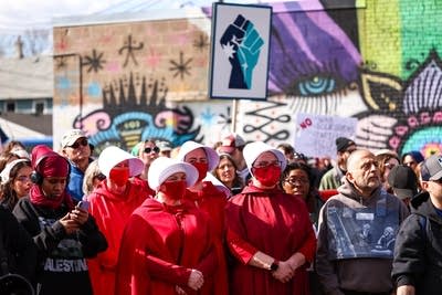 Demonstrators look on during a Workers Day March