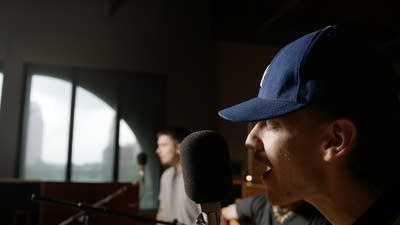 Three musicians performing in a recording studio