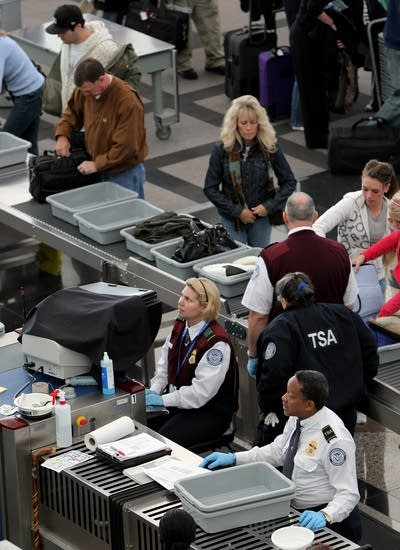 TSA officials conduct security screenings