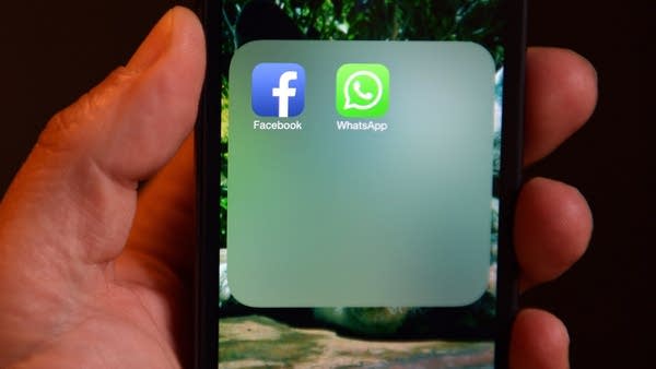 Icons for Facebook and WhatsApp on a smartphone display. Facebook, which bought WhatsApp in 2014, announced its purchase of Giphy this month. 