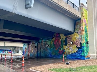 A view of a mural under a bridge.
