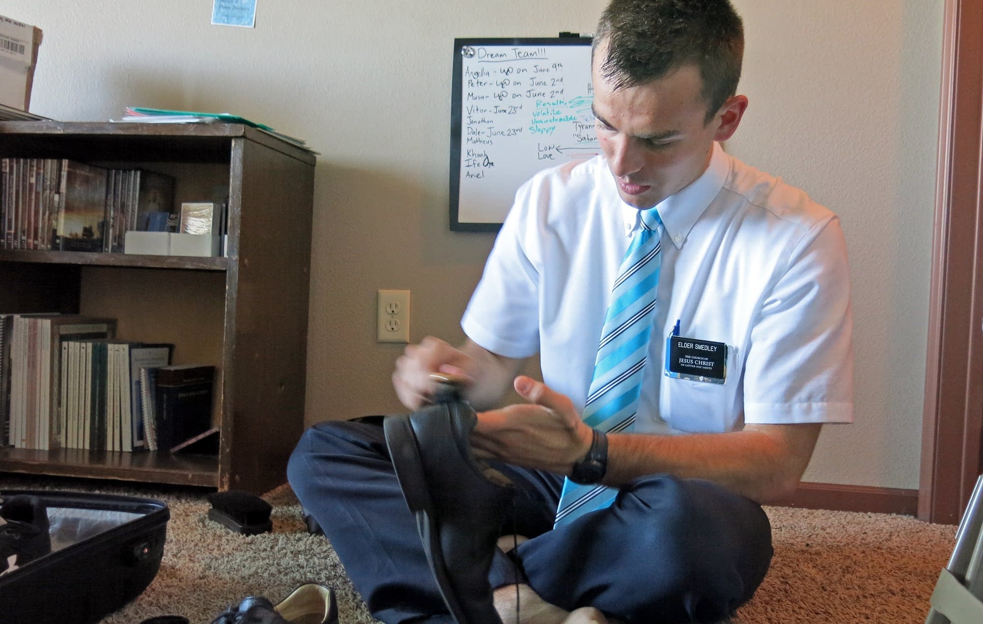 Tanner Smedley gets ready for a day of missionary work, shining his shoes.