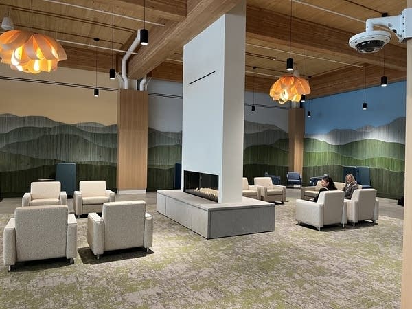 A seating area with a fireplace at Burlington, Vermont's airport