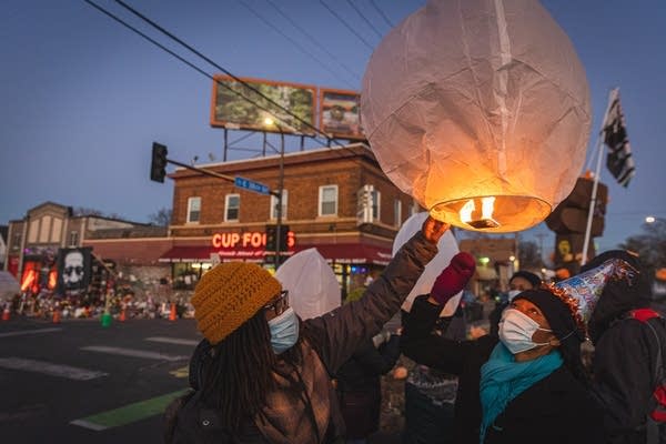 People launch a paper lantern