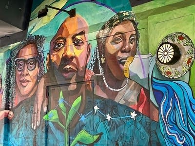 A view of a mural under a bridge.